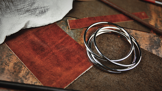 Set of silver bangles on textured leather background