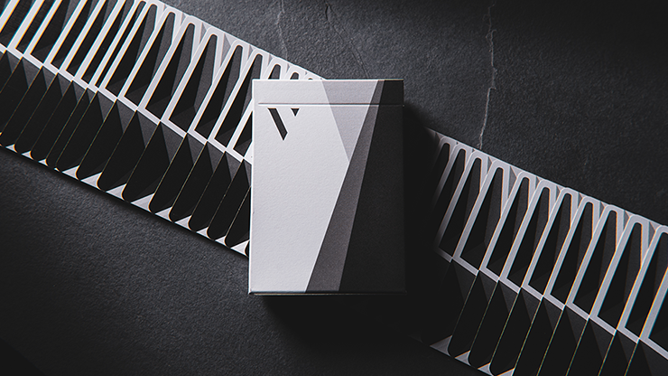 White and black playing cards with geometric design in a box