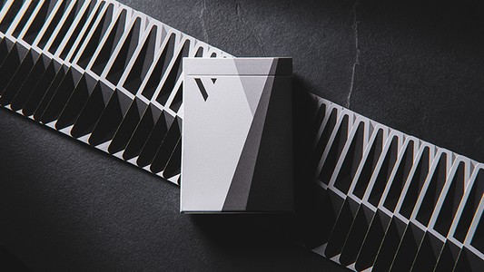 White and black playing cards with geometric design in a box